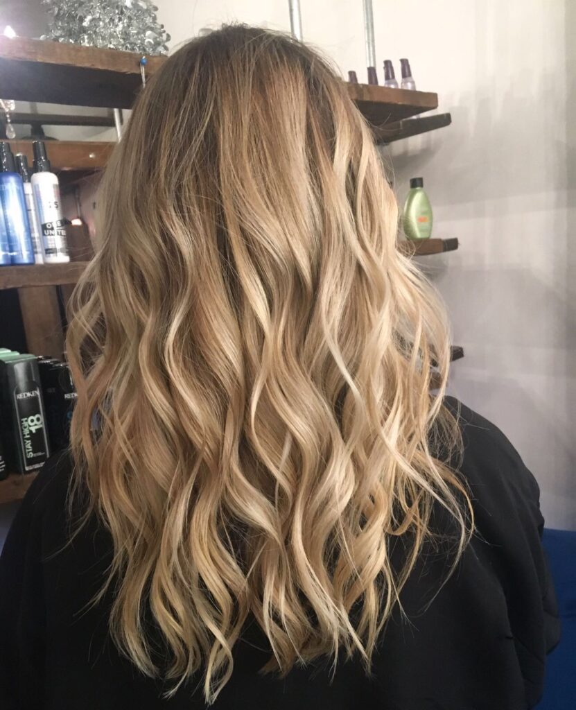 Blonde balayage with curly blow dry in the Brixton London salon