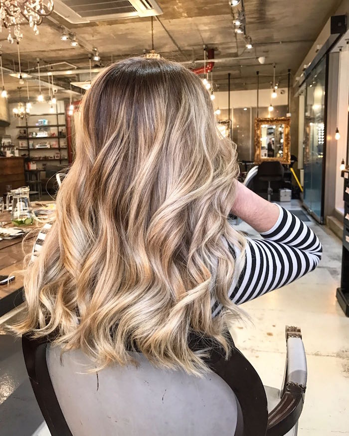 woman with beautiful natural looking blonde balayage at a hair salon in nine elms